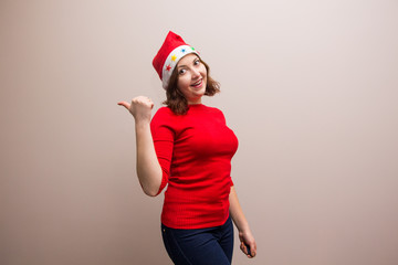 happy girl in santa hat in red blouse on white background 