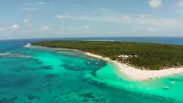 Seascape with beautiful beach and tropical island palm trees by coral reef from above. Daco island, Philippines. Summer and travel vacation concept