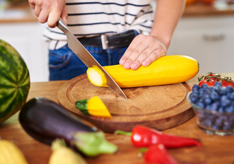 Woman cutting zucchini into slices