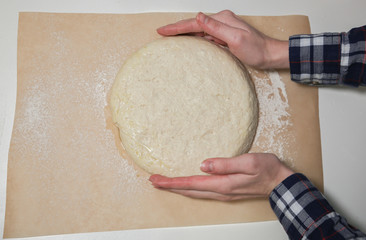 Yeast dough on the table. Baking concept. Cooking ideas. Woman's hands making homemade food. Knead flour and water.