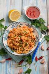 spaghetti with squid tomato sauce parsley and hot chili pepper