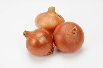 several ripe onions isolated on a light background