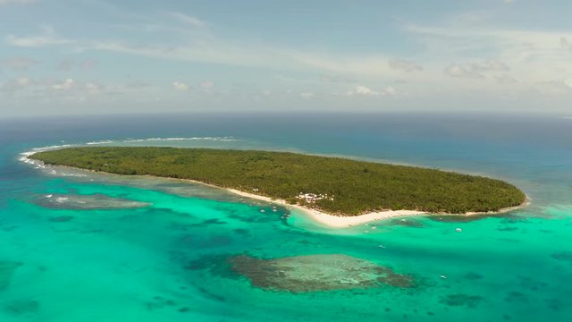 Seascape with beautiful beach and tropical island palm trees by coral reef from above. Daco island, Philippines. Summer and travel vacation concept