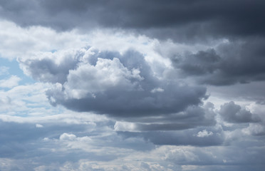 huge heavy thunderclouds in the blue sky before a thunderstorm, sky background