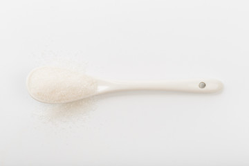 Spoon of fine granulated sugar isolated on white  - Image