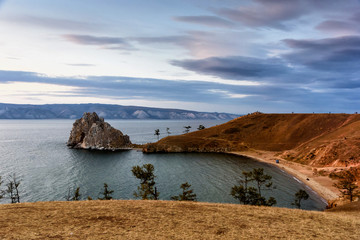 Fototapeta na wymiar Lake Baikal, trees and mountains of Siberia with beautiful sky and clouds, Russia Oklhon island