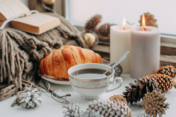 coffee mug on the windowsill with a book