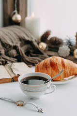 coffee mug on the windowsill with a book