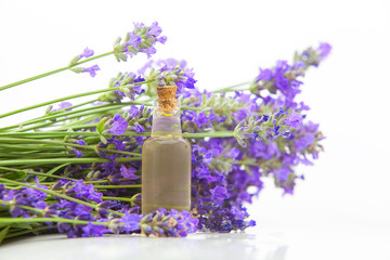 Obraz na płótnie Canvas lavender essential oil in beautiful bottle on White background