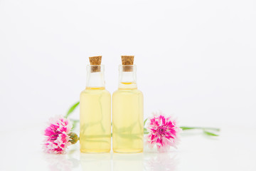 Fototapeta na wymiar Essence of lavender flowers on White background in beautiful glass Bottle