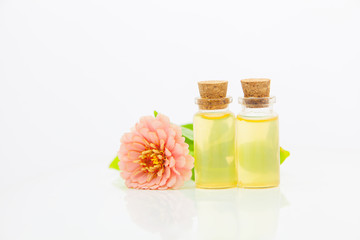 Zinnia essential oil in  beautiful bottle on White background