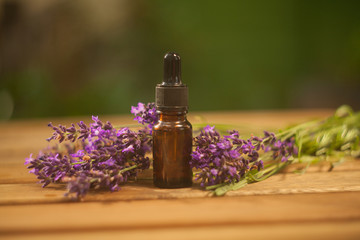 Obraz na płótnie Canvas lavender essential oil in beautiful bottle on table