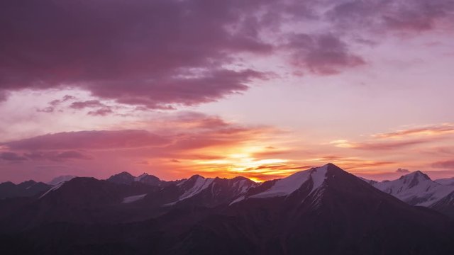Time lapse panorama of Tian Shan mountain peaks with glaciers at sunrise
