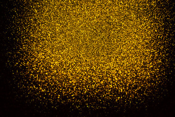 Abstract gold glister defocused on black background vignette use us gold luxury background for...