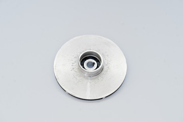 Spare part round disc for water pump isolated on white.