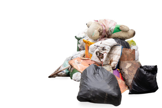 Teddy bear on the garbage pile isolated in white background.