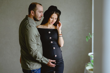 Happy family waiting for a child. Home background.