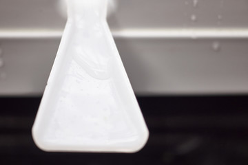 defrosting the refrigerator. water flows down a plastic gutter.
