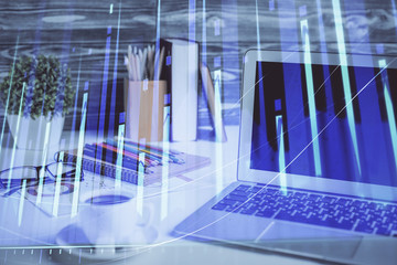 Fototapeta na wymiar Stock market chart hologram drawn on personal computer background. Multi exposure. Concept of investment.