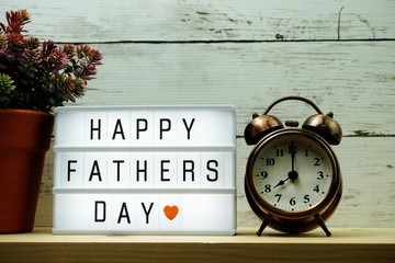 Happy Fathers Day word on light box and alarm clock
