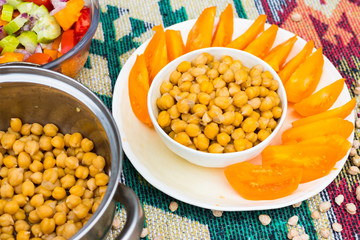 Homemade cooked chickpea bowl with vegetables (tomatoes).