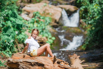 Little girl enjoying view of waterfall in Krasnay Poliana