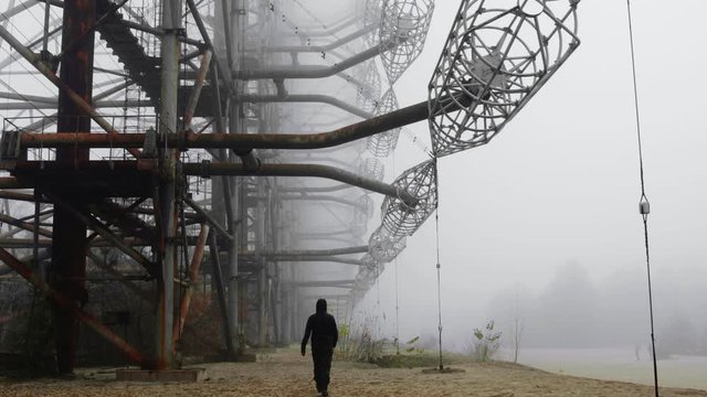 Man walking at Duga Antenna Complex in Chernobyl Exclusion zone 2019