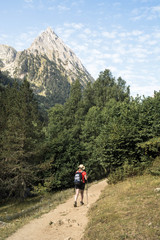 Fototapeta na wymiar woman hiking in the national park d´aiguestortes in the Pyrenees in Spain