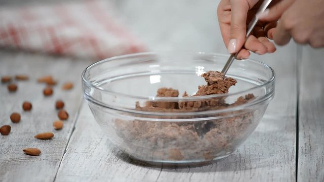 The process of making chocolate base for cake. Working with dough at home kitchen. Close-up.
