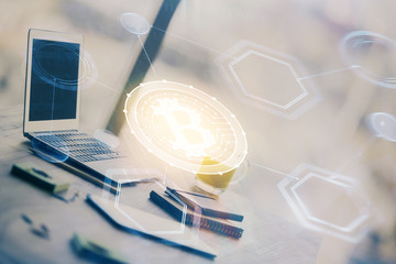 Double exposure of blockchain and crypto economy theme hologram and table with computer background. Concept of bitcoin cryptocurrency.