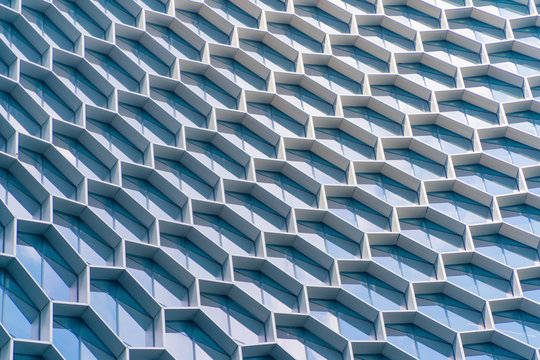 Office Buildings. Structure Of Hexagon Windows In Futuristic Technology Network Connection Concept. Blue Glass Modern Architecture Facade Design With Reflection Of Sky In Urban City, Downtown.