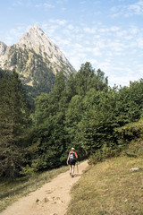 Fototapeta premium woman hiking in the national park d´aiguestortes in the Pyrenees in Spain