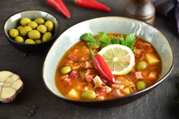 traditional russian meat soup solyanka. The finished dish. Close-up.