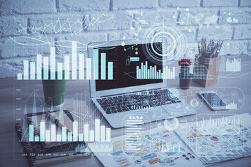 Financial graph colorful drawing and table with computer on background. Double exposure. Concept of international markets.