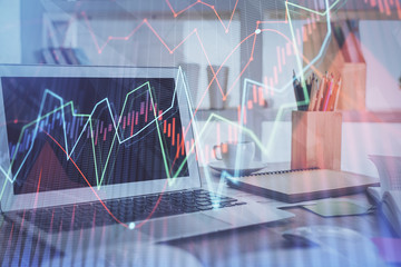 Stock market chart hologram drawn on personal computer background. Double exposure. Concept of investment.