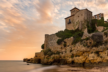 Castle of Tamarit seen from the beach on the sunset, Tarragona province, Catalonia, Spain. - obrazy, fototapety, plakaty