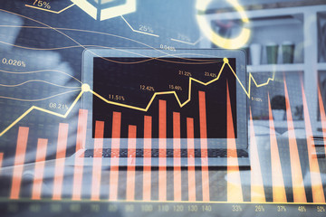 Stock market graph and table with computer background. Multi exposure. Concept of financial analysis.