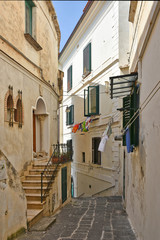 Fototapeta na wymiar The narrow street among the old houses of the town of Amalfi in Italy