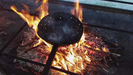 Steaming chestnuts cooking over the fire, Vittorio Veneto, Italy