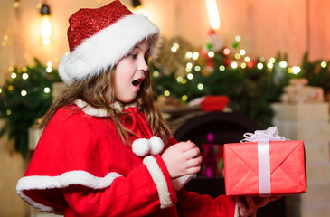 Try it. Happy new year. Elf child. Xmas tree. Happy holiday. Little girl in red hat. Happy christmas. Santa claus little girl. Chriatmas interior. Christmas time. present box. shopping sale