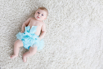 Adorable baby girl on white background wearing turquoise tutu skirt. © Irina Schmidt