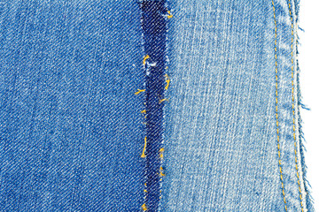 Piece of blue jeans fabric with ripped of back pocket