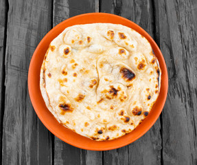 Indian Cuisine - Tandoori Roti whole wheat flat bread made from stoneground wholemeal flour, Traditionally known as atta, and water that is combined into a dough