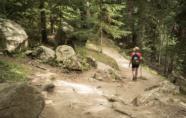woman hiking in the national park d&acute;aiguestortes in the Pyrenees in Spain