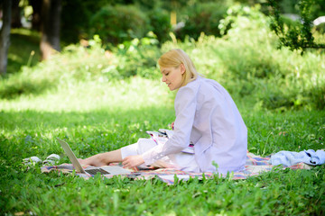 Naklejka na ściany i meble Business lady freelance work outdoors. Freelance career concept. Guide starting freelance career. Managing business outdoors. Woman with laptop sit grass meadow. Become successful freelancer
