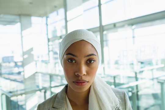 Businesswoman in hijab looking at camera in a modern office