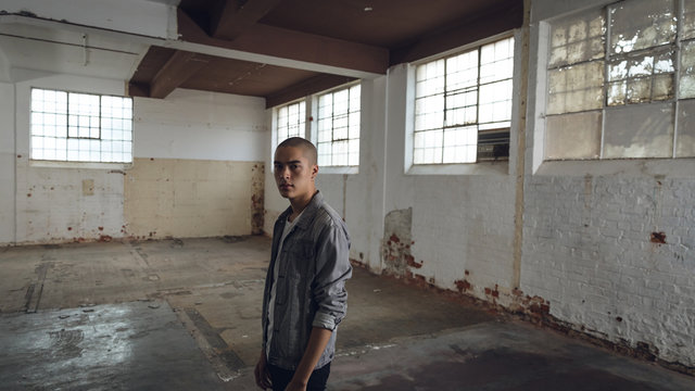 Young man inside an empty warehouse