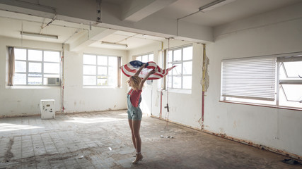 Young woman inside an empty warehouse