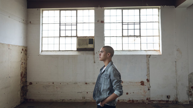 Young man inside an empty warehouse