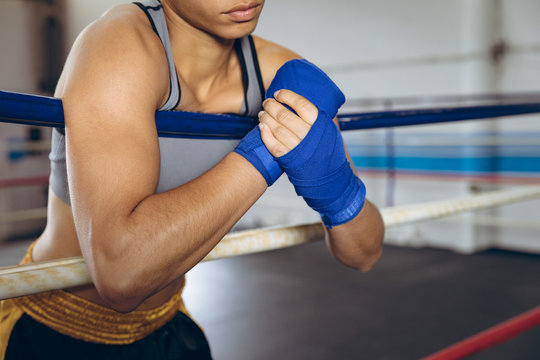 Female boxer wearing hand wrap at boxing club